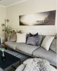 Stilfull lounge med soffa, kuddar och modern inredning på Hankø Hotell